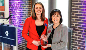 Two women holding award