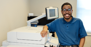Image of a smiling man with printer