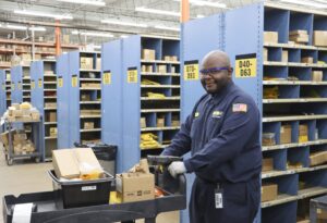 Man pushing cart in warehouse